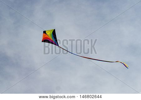 colorful kite flying on a clear blue autumn sky