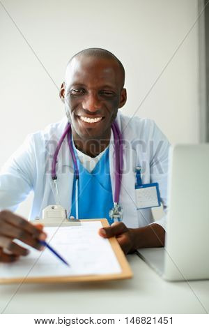 Male doctor sitting at his desk
