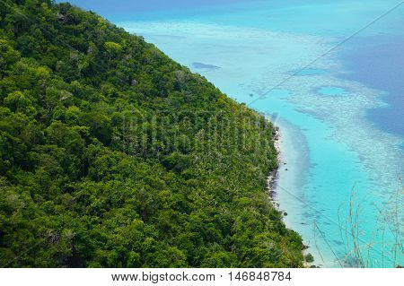 National Park on top of Bohey Dulang island near Sipadan Island,Sabah,Borneo. Mirror smooth ocean surrounded by mountains. The bright blue water and rocky shore in the tropical island of Borneo.