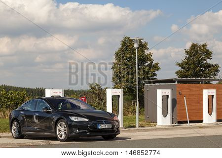 WILNSDORF GERMANY - SEP 1 2016: Tesla Model S electric car being charged at the Tesla Supercharger station