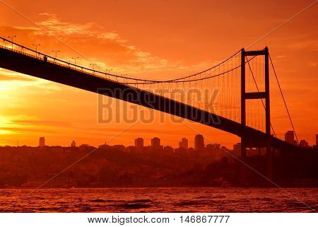 Bosphorus Bridge in Istanbul at sunset in orange tones
