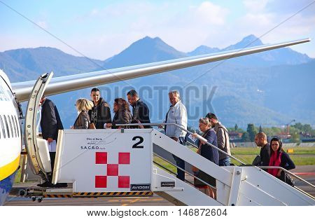 BERGAMO, ITALY - APRIL 25, 2016: Passengers boarding Ryanair aircraft at Orio Al Serio international airport