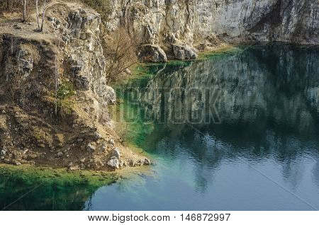 Beautiful view on azure lake and cliffed coast in in the autumn
