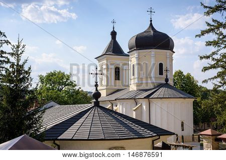 Photo of Capriana Monastery in Moldova with blue sky