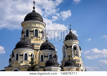 Photo of Capriana Monastery in Moldova with blue sky