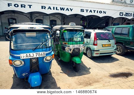COLOMBO SRI LANKA - FEBRUARY 16 2016: Tuk tuk taxis parked in front of Colombo Fort train station. Tuk tuk and train are the most common transportation in Sri Lanka