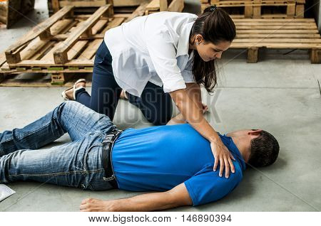 girl assisting an unconscious man after fatal accident