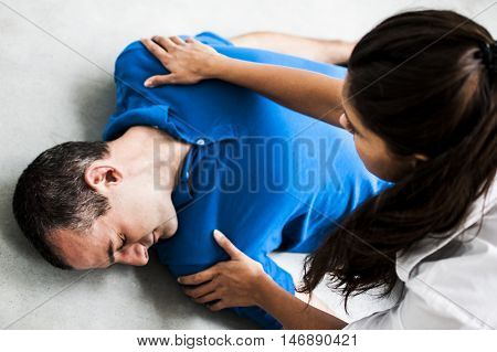 girl assisting an unconscious man after fatal accident