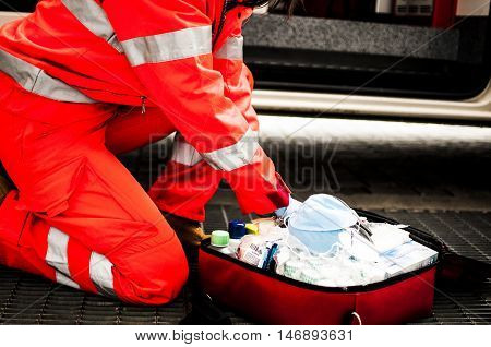 girl emergency volunteer operator with emergency bag and medical devices