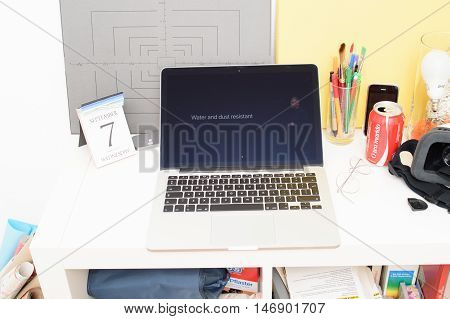 PARIS FRANCE - SEP 8 2016: Apple Computers website on MacBook Retina in room environment showcasing live coverage of Apple Keynote - presentation of iPhone new photo camera double camera