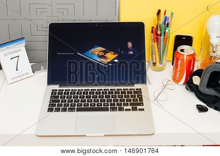 PARIS FRANCE - SEP 8 2016: Apple Computers website on MacBook Retina in room environment showcasing live coverage of Apple Keynote - presentation of iPhone new photo camera double camera