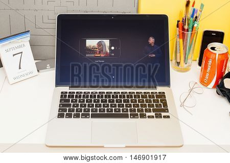 PARIS FRANCE - SEP 8 2016: Apple Computers website on MacBook Retina in room environment showcasing live coverage of Apple Keynote - presentation of iPhone new photo camera double camera