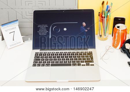 PARIS FRANCE - SEP 8 2016: Apple Computers website on MacBook Retina in room environment showcasing live coverage of Apple Keynote - presentation of iPhone new photo camera double camera