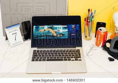 PARIS FRANCE - SEP 8 2016: Apple Computers website on MacBook Retina in room environment showcasing live coverage of Apple Keynote - Apple COO Jeff Williams on stage about waterproof apple watch