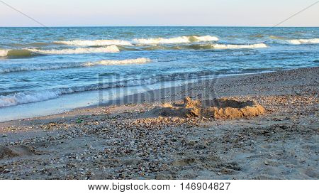Photo sandy beach, washed by the sea wave. Photo taken on the coast of the Azov Sea in August 2016.