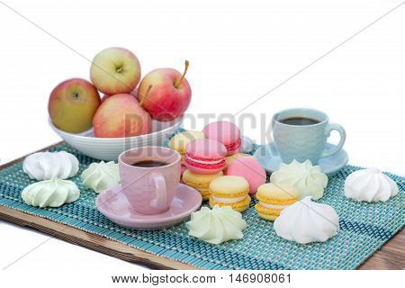 Still life of served coffee cups macaroon cookies marshmallows and apples