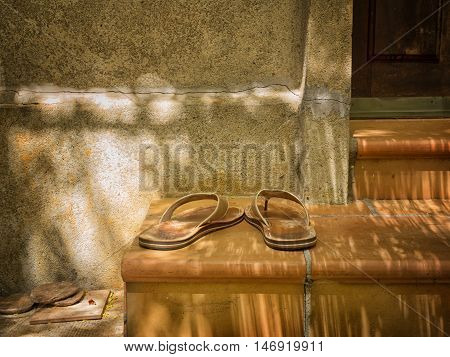 Slippers on the steps of a porch