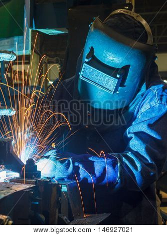 welder welding Industrial automotive part in factory