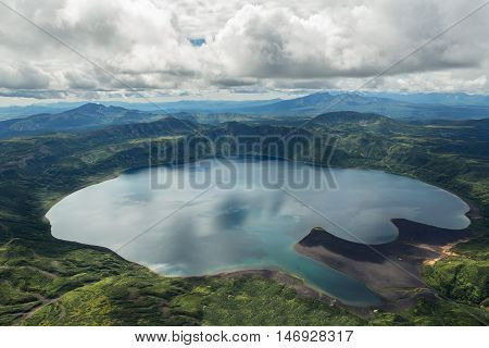 Crater Karymsky Lake. Kronotsky Nature Reserve on Kamchatka Peninsula. View from helicopter.