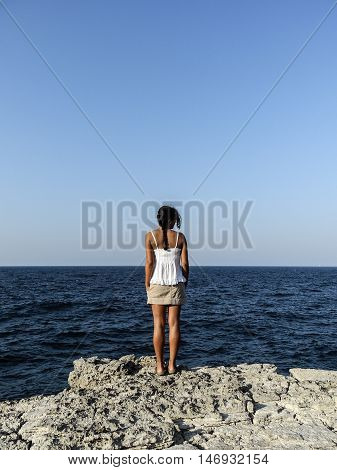 girl admiring the deep blue sea by the riff