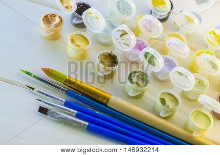 set of colored acrylic paints and brushes for drawing