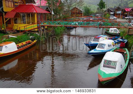 PASTO, COLOMBIA - JULY 3, 2016: small colorfull boats parked in a shore of la cocha lake in the south of colombia
