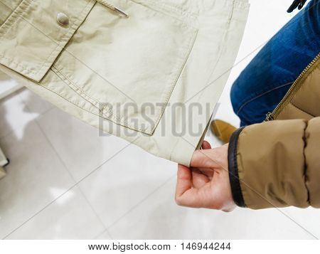 Shopping time concept. Part body buyer customer client wathing touching clothes in botique shop market.