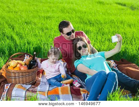 Picnic on the grass. Happy family, healthy lifestyle