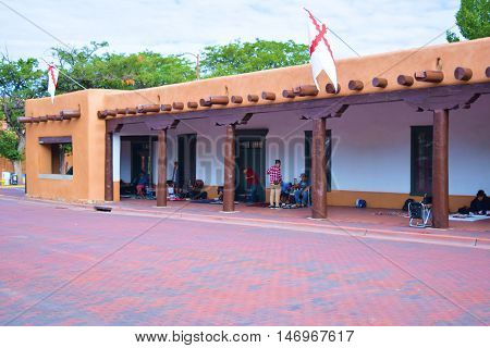 Santa Fe, NM - September 12, 201:  Historic adobe style Palace of the Governor's Building built in 1610 which has been a seat of government for New Mexico during centuries and where Native Americans sell and trade their merchandise at the courtyard.