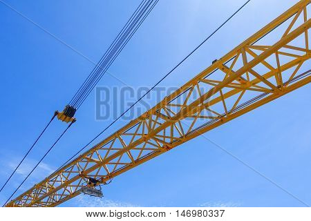 Crane boom structure and metal sling on blue sky background
