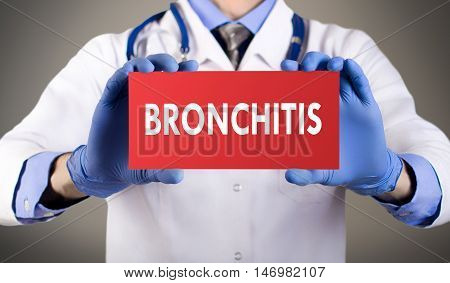 Doctor's hands in blue gloves shows the word bronchitis. Medical concept.