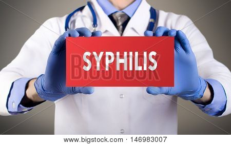 Doctor's hands in blue gloves shows the word syphilis. Medical concept.