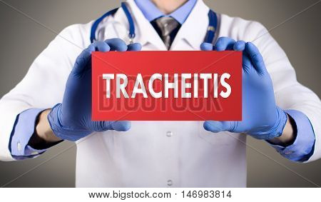 Doctor's hands in blue gloves shows the word tracheitis. Medical concept.