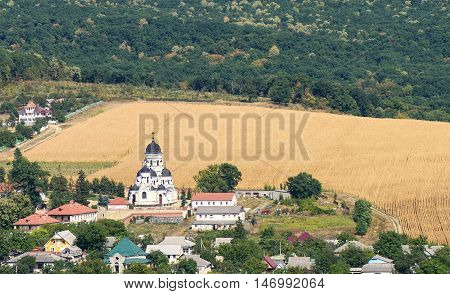 Landscape view with Capriana Monastery and the village in Moldova surrounded by forest