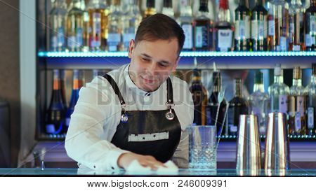 Bartender Wiping Down Bar Counter. Close Up. Professional Shot In