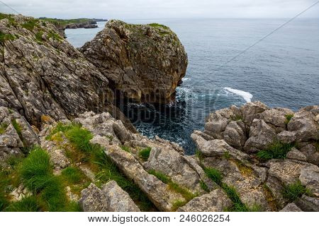 Coastal cliffs near of the beach Gulpiyuri, Asturias, Spain