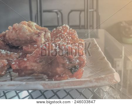 On Seletive Focus And Dark Image Of Fried Chicken Sauce Cook A Special Dish In Black. And The Teacup