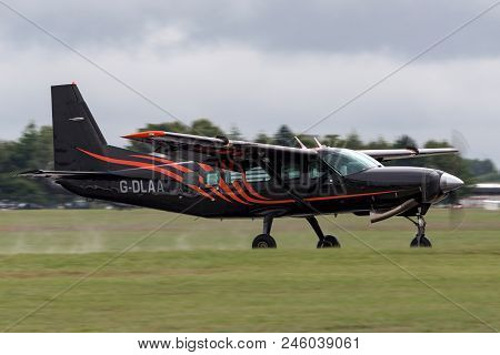 Raf Waddington, Lincolnshire, Uk - July 5, 2014: Cessna 208 Caravan G-dlaa Touching Down On The Runw