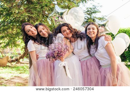 Happy Lovely Girlfriends In Pink Tulle Skirts Having Fun At Hen Party Outdoors