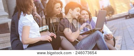 Group Of Fellow Students With Books And Laptop.education Concept