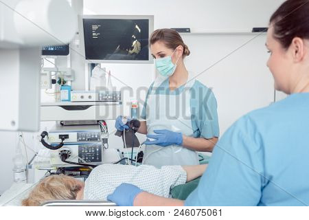 Internist doctors during stomach examination working as a team