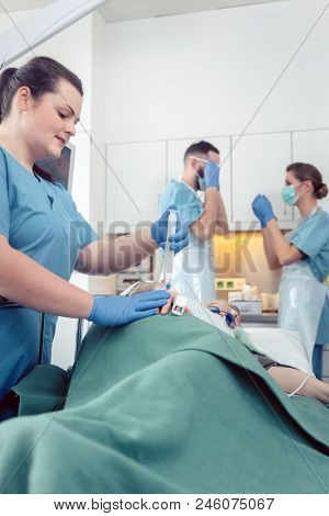 Nurse giving anesthesia to patient waiting for endoscopy examination in hospital