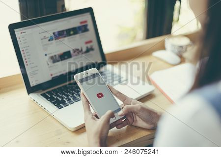 Singapore.february, 2018:a Woman Holding Iphone With Video Service Youtube On The Screen. Iphone Was