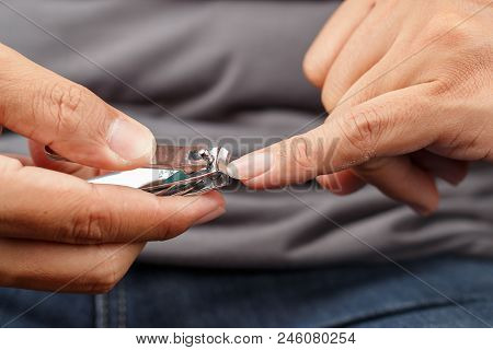 Close Up Man Hands Cutting Finger Nails