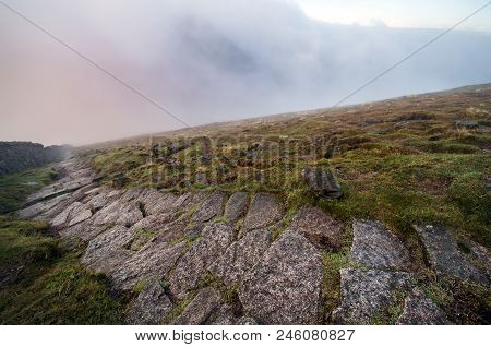 A View Along The Pathway Down Slieve Donard Into Colorful Clouds.