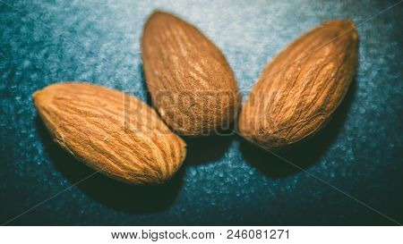 Raw Almonds Nuts On The Wooden Background