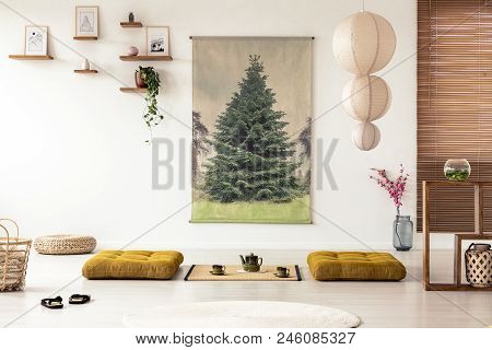 Japanese Dining Room Interior With A Tree Poster, Lamp, Pillows And Tatami Mat With Pot And Cups On