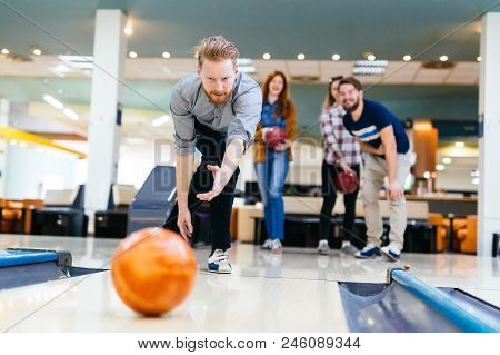 Friends Having Fun While Bowling And Speding Time Together