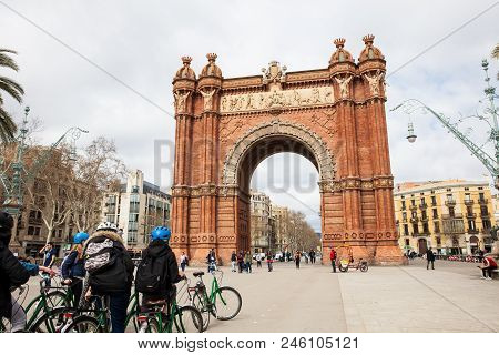 Barcelona - March, 2018: Barcelona - March, 2018: People On A Bike Tour At The Triumphal Arch In Bar