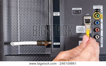 Close Up Of Senior Caucasian Man Hand Plugging Internet Into Smart Tv After Cutting The Cable Tv Cor